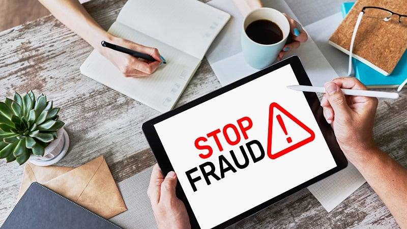 team-working-on-tablet-to-stop-ad-fraud